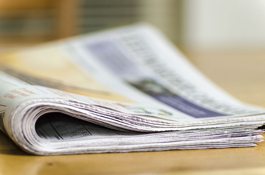 Free newspaper on table closeup