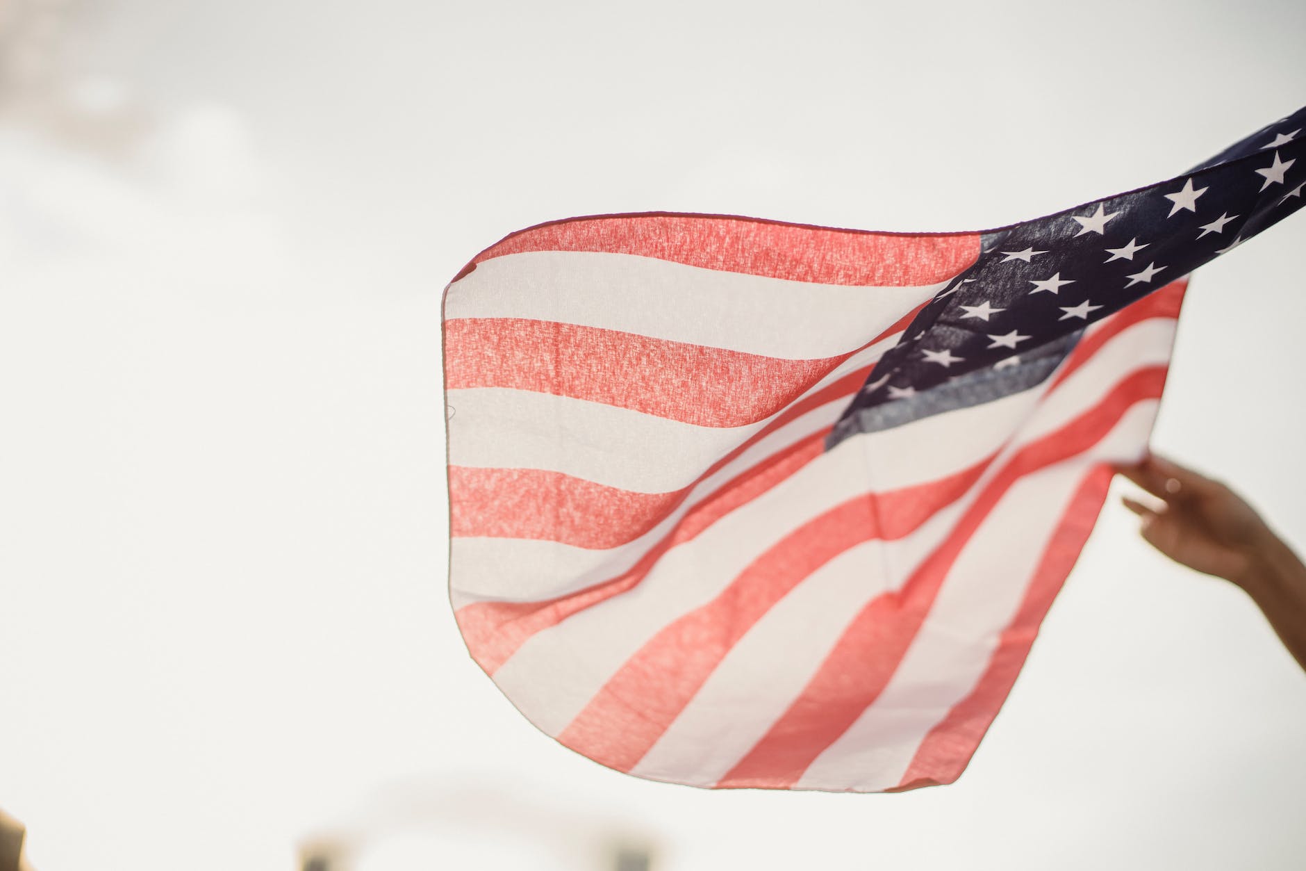 person holding an american flag - conspiracy America: Suspicious minds