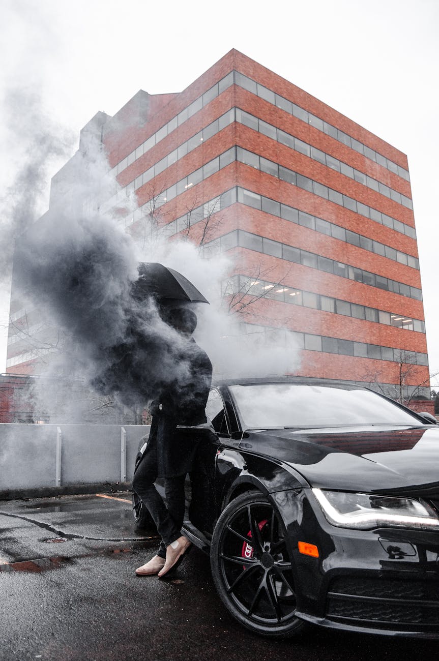 photo of man leaning on black car