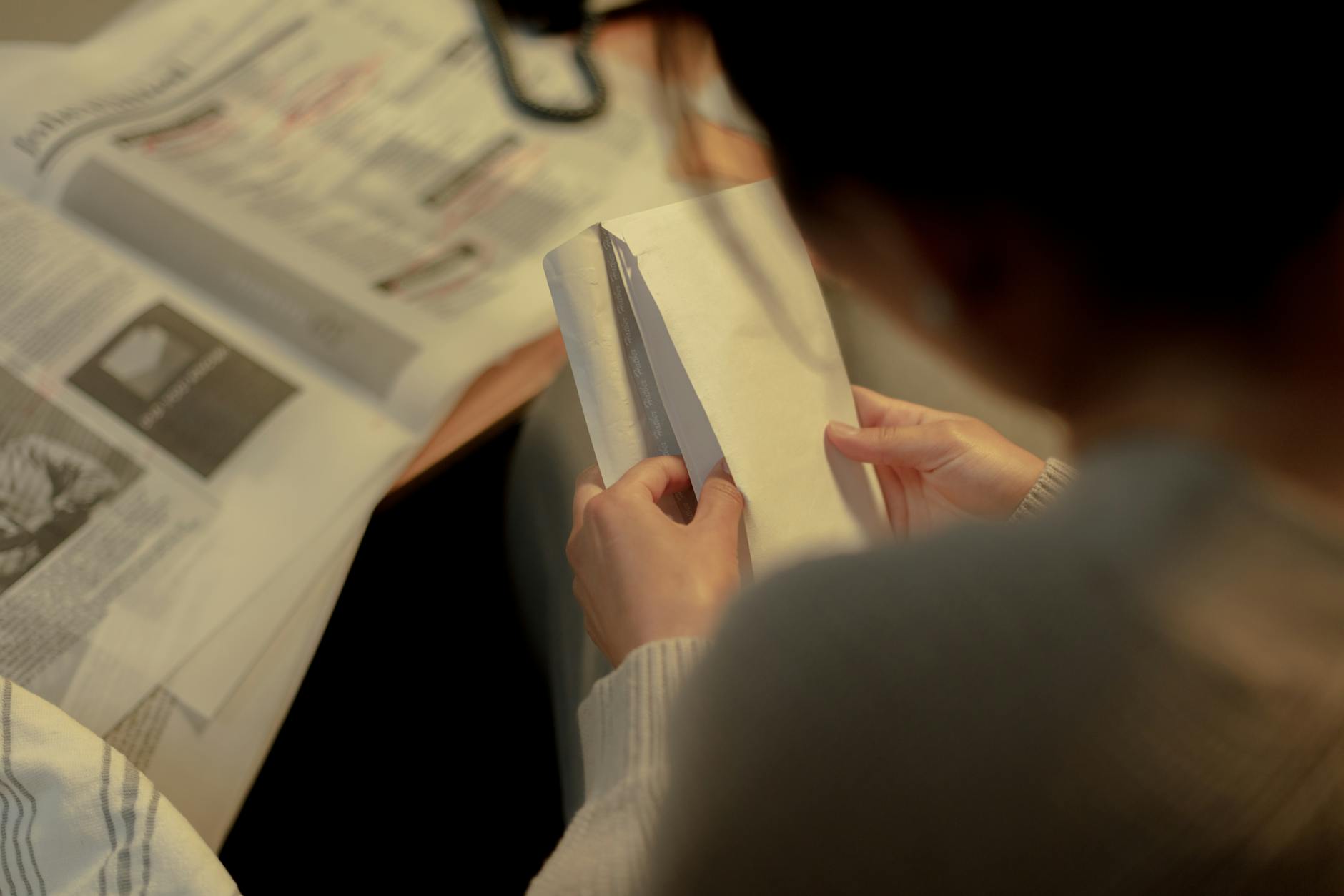 rear view on woman opening letter